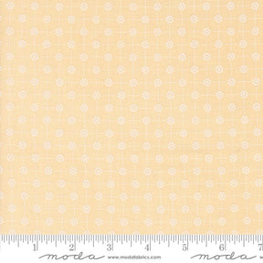 a ruler with a yellow background with white flowers