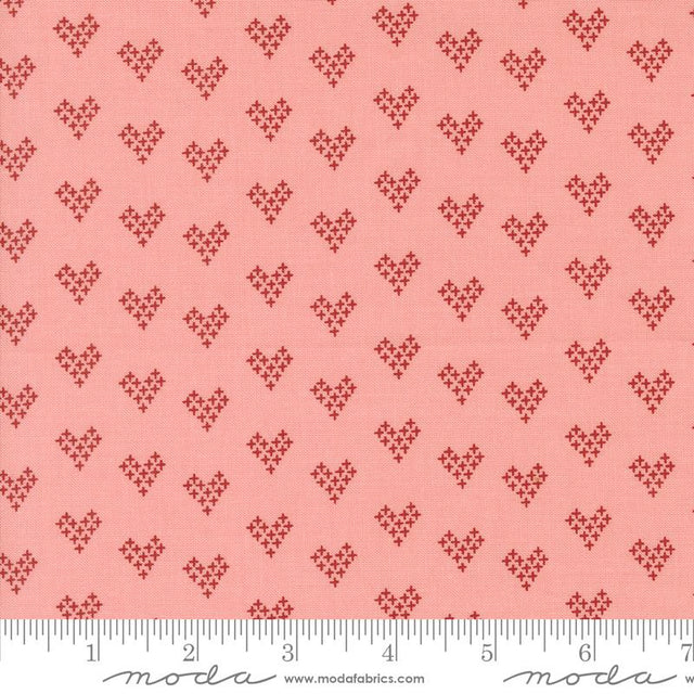a pink background with small hearts on it