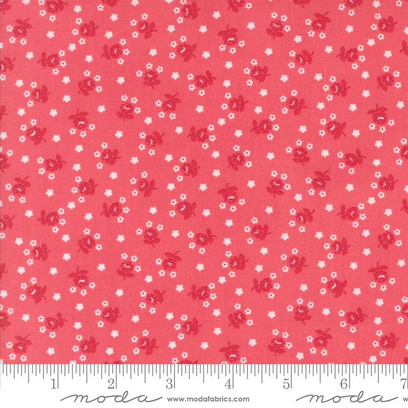 a red fabric with white flowers on it