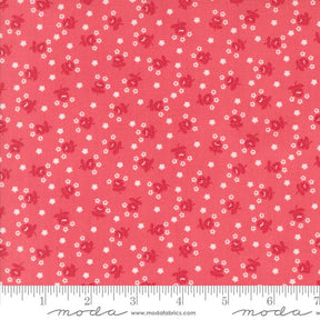 a red fabric with white flowers on it