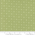 a green fabric with white circles and crosses on it