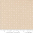 a beige fabric with small white dots on it