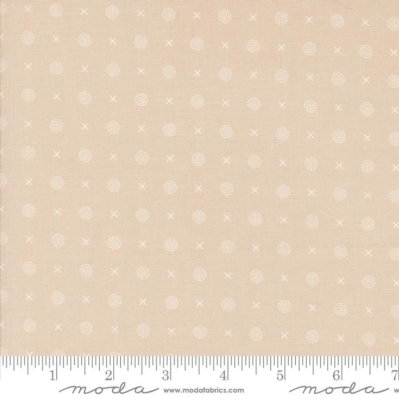 a beige fabric with small white dots on it
