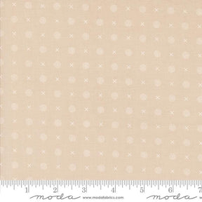 a beige fabric with small white dots on it