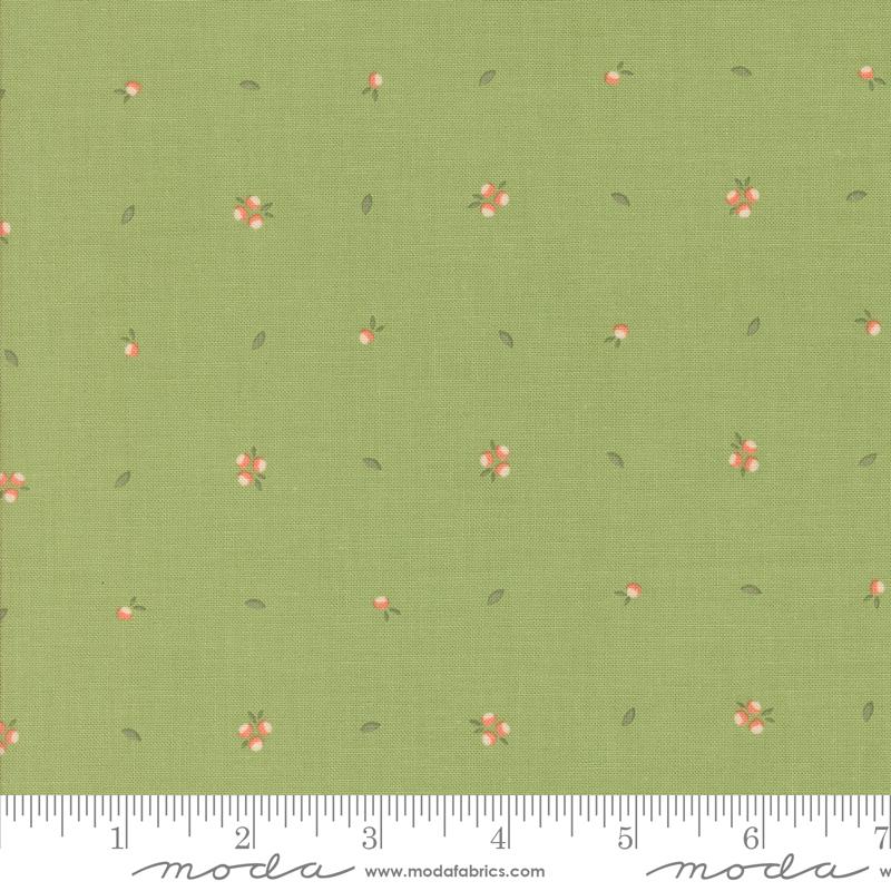a green fabric with small pink flowers on it