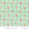 a green background with pink flowers and polka dots