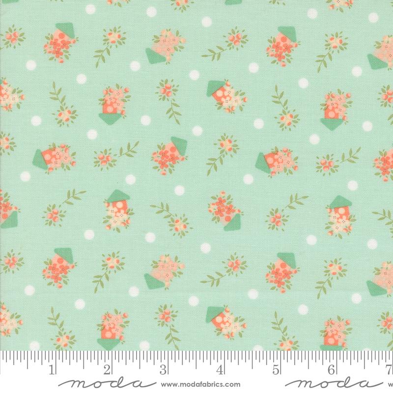 a green background with pink flowers and polka dots