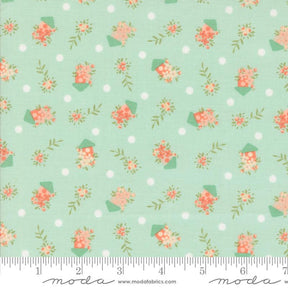 a green background with pink flowers and polka dots