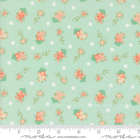 a green background with pink flowers and polka dots
