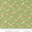 a green background with pink flowers and polka dots