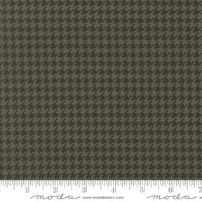 a brown and black checkered fabric with a ruler
