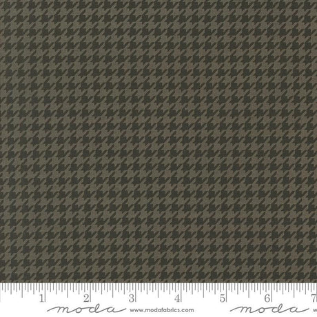 a brown and black checkered fabric with a ruler
