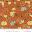 an orange background with pumpkins and faces