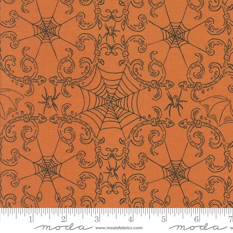 an orange background with a spider web pattern
