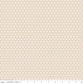 a beige background with small blue and green dots