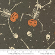 a halloween themed fabric with skeletons and pumpkins