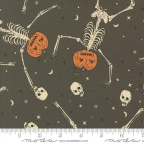 a halloween themed fabric with skeletons and pumpkins