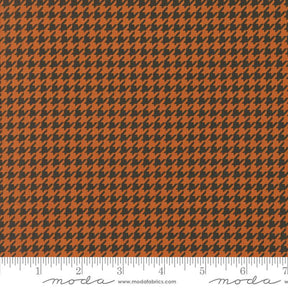 an orange and black checkered fabric with a ruler