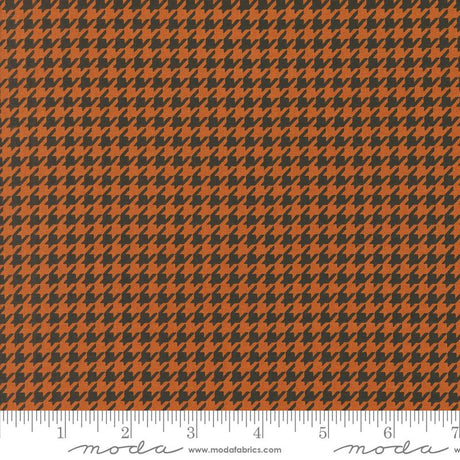 an orange and black checkered fabric with a ruler