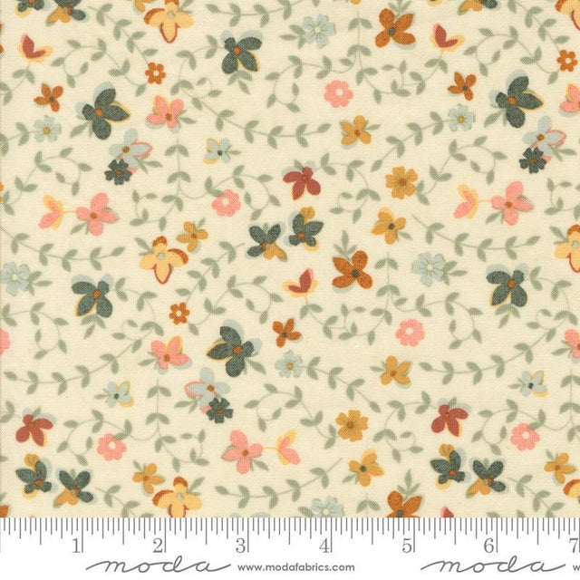 The image is a fabric with a floral pattern, featuring various shades of green, orange, and pink flowers and leaves. The fabric appears to be a light-colored material, possibly cream or pale yellow, with a repeating pattern of flowers and leaves. The image does not contain any text or specific details about the objects or their arrangement.