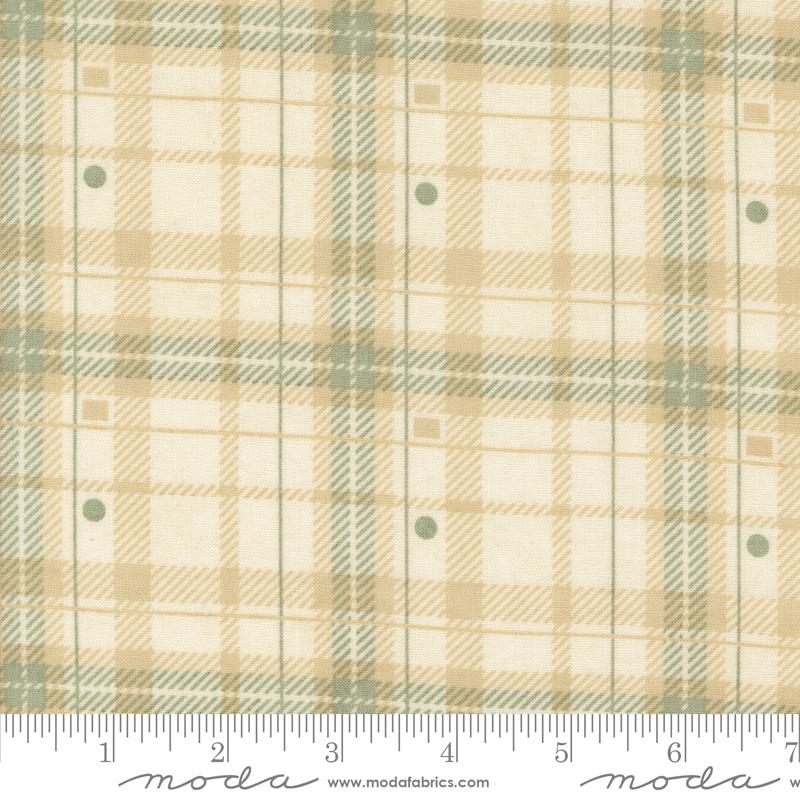 a fabric with a plaid pattern in shades of beige and green. The fabric appears to be a textile, possibly used for clothing or home decor.