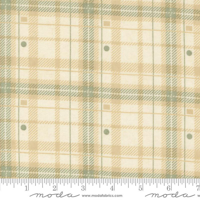 a fabric with a plaid pattern in shades of beige and green. The fabric appears to be a textile, possibly used for clothing or home decor.