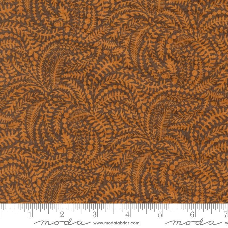 The image is a close-up of a fabric with a repeating pattern of brown leaves and acorns. The pattern is intricate and detailed, creating a visually appealing design.