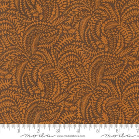 The image is a close-up of a fabric with a repeating pattern of brown leaves and acorns. The pattern is intricate and detailed, creating a visually appealing design.