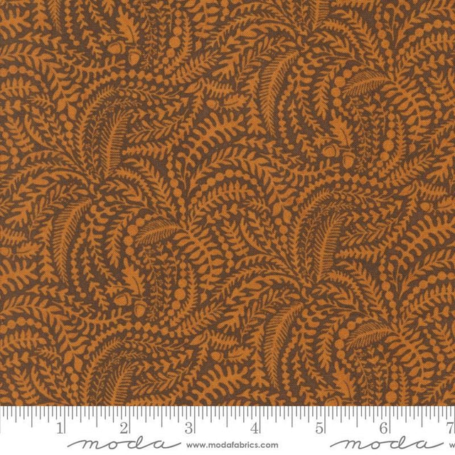 The image is a close-up of a fabric with a repeating pattern of brown leaves and acorns. The pattern is intricate and detailed, creating a visually appealing design.