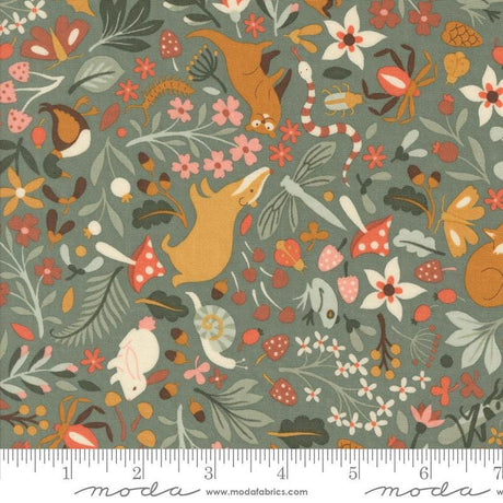 The image is a vibrant and colorful fabric with various animals, flowers, and leaves printed on it. The fabric appears to be a part of a larger textile or garment, as indicated by the ruler for scale.