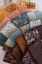 The image is a collage of various fabric swatches, each with different patterns and colors, arranged in a visually appealing manner.