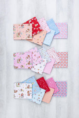 A collection of colorful fabric squares with various patterns, including animals, flowers, and geometric designs, arranged in a visually appealing manner.
