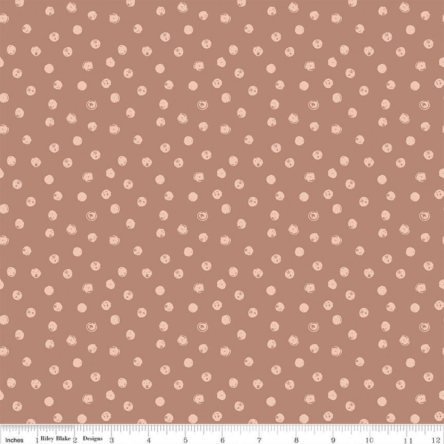a repeating pattern of small white dots on a brown background.