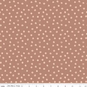 a repeating pattern of small white dots on a brown background.