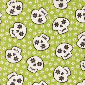 a repeating pattern of stylized skull faces on a green background with white flowers.