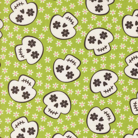 a repeating pattern of stylized skull faces on a green background with white flowers.