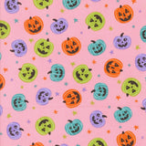 a repeating pattern of Halloween pumpkins and stars on a pink background.
