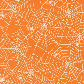 a repeating pattern of white spider web designs on an orange background.