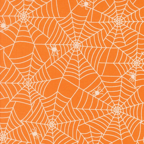 a repeating pattern of white spider web designs on an orange background.