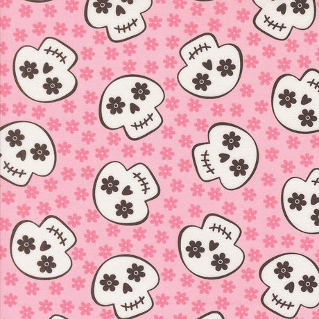 a repeating pattern of stylized skull faces on a pink background with small pink flowers scattered throughout.
