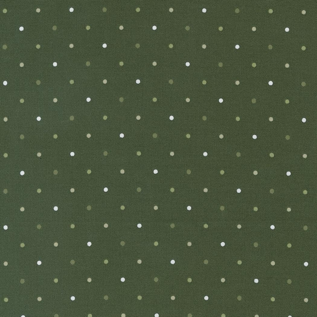 a green background with white polka dots