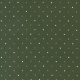 a green background with white polka dots