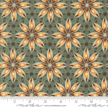 a repeating pattern of stylized orange and brown flowers on a green background, with a ruler for scale.
