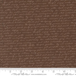 a brown fabric with a repeating pattern of cursive text, which appears to be a printed design. The text is not uniform and varies in size and style, creating a visually interesting and textured appearance.