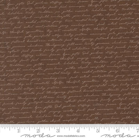 a brown fabric with a repeating pattern of cursive text, which appears to be a printed design. The text is not uniform and varies in size and style, creating a visually interesting and textured appearance.