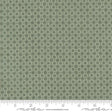 a close-up view of a fabric with a repeating pattern of green circles on a white background.