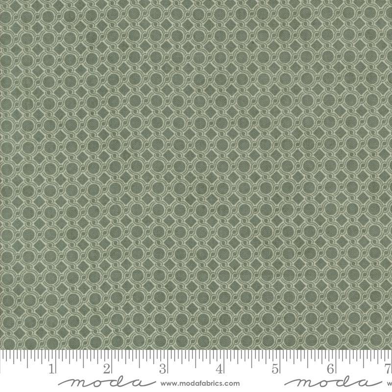 a close-up view of a fabric with a repeating pattern of green circles on a white background.