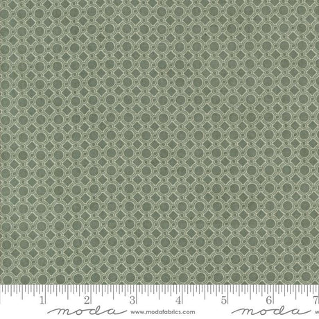 a close-up view of a fabric with a repeating pattern of green circles on a white background.