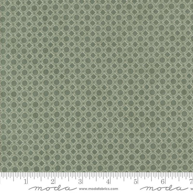 a close-up view of a fabric with a repeating pattern of green circles on a white background.