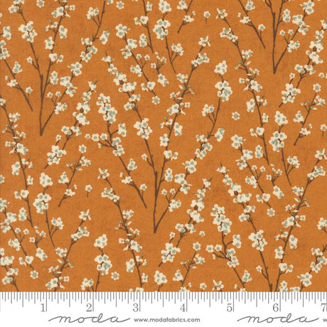a repeating pattern of white flowers on brown branches against an orange background.